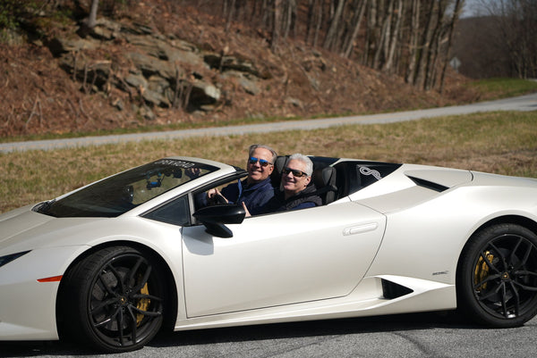 2 men in convertible on road