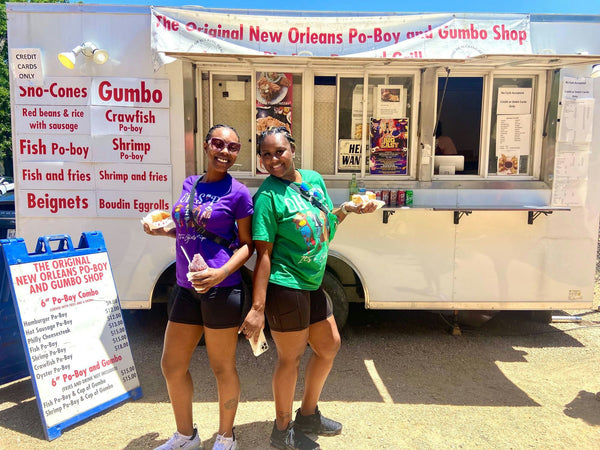 2 women in front of food truck