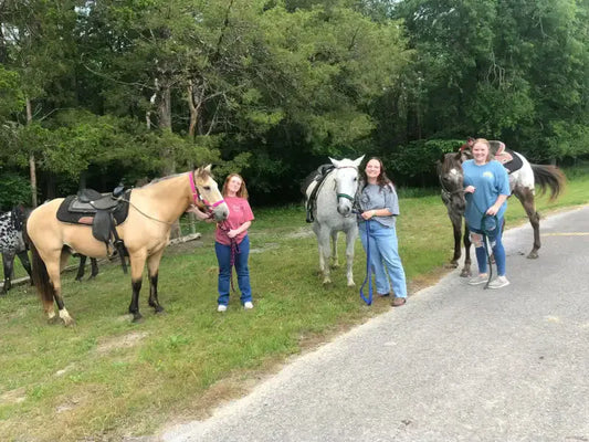 3 girls with horses.webp