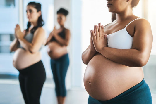 3 women doing prenatal yoga