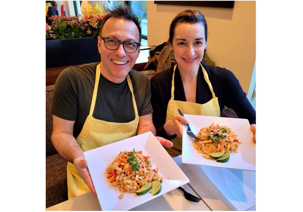 Plated sushi with ingredients and persons hand