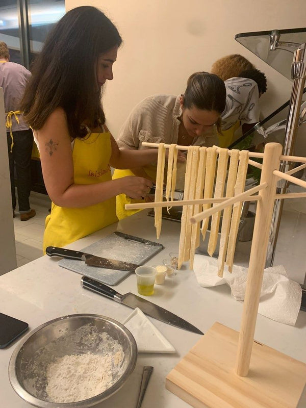 Fresh pasta in flour on table