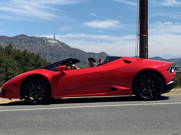 Lambo parked on street with palm trees