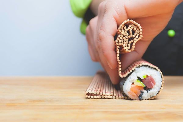 Rice with seaweed on a rolling sheet