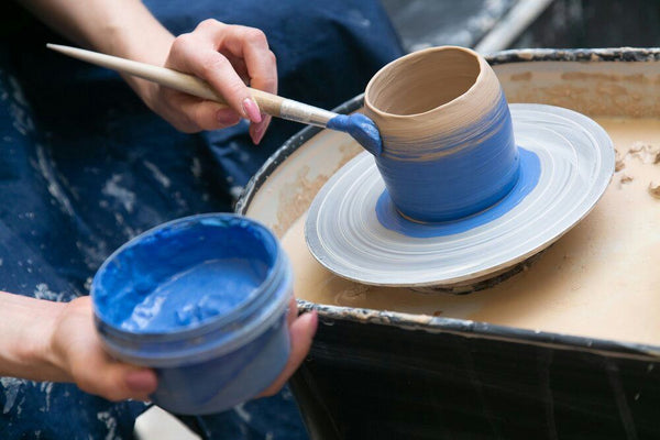 couple working at pottery wheel