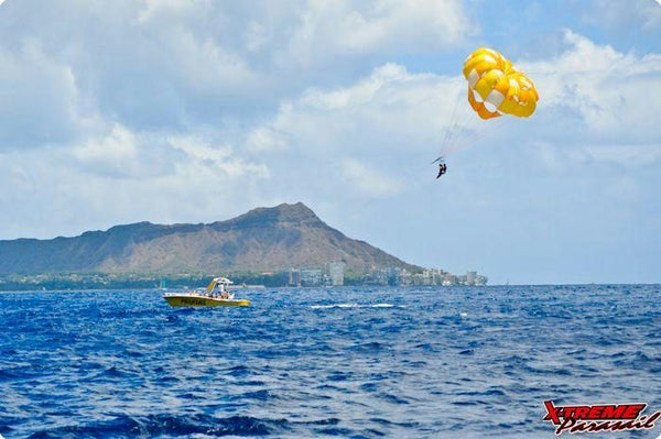 boat carrying yellow parasail