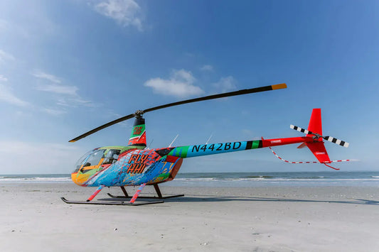 colorful helicopter on sand.webp