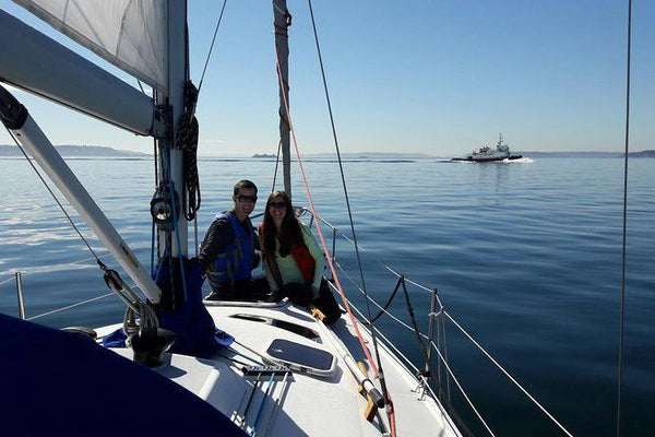 couple helping at front of boat