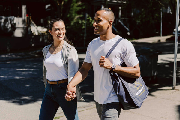 couple holding hands with picnic bag