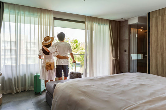 couple looking out window in hotel