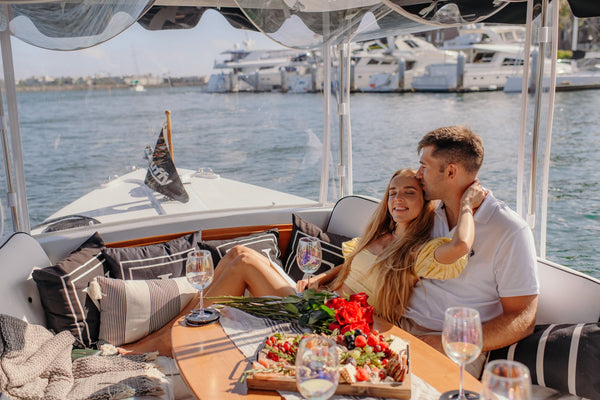 couple riding the back of a boat