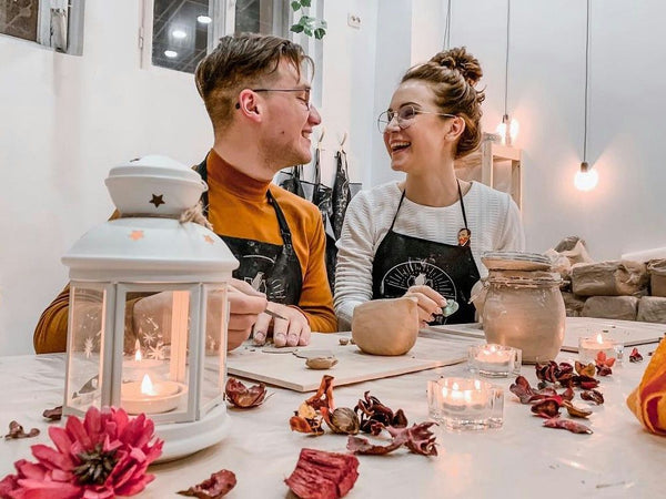 couple working at pottery wheel