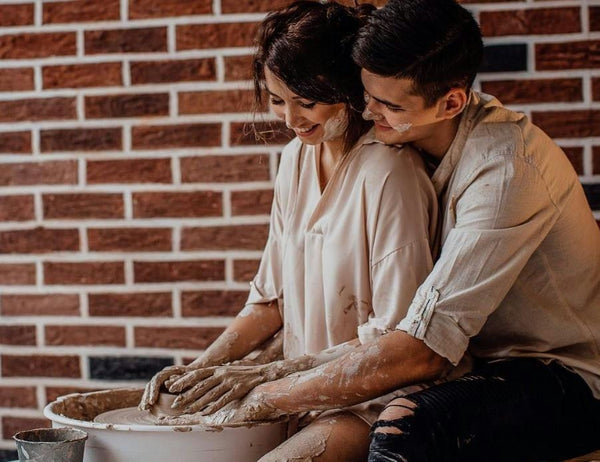 couple working at pottery wheel