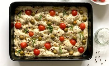 dough with tomatoes and olives