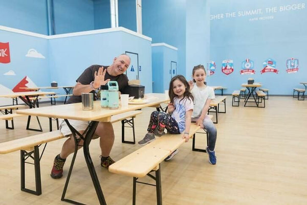 family enjoying snacks at climbing gym