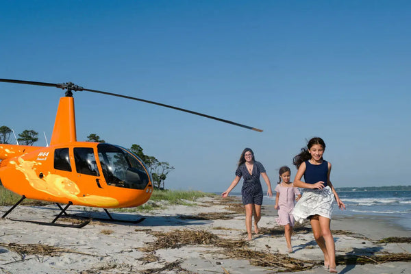 family on beach with helicopter.webp