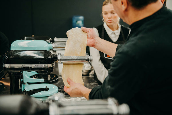 feeding pasta through maker