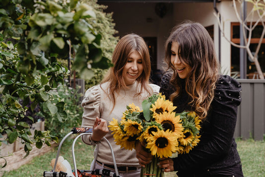 girls carrying basket and flowers