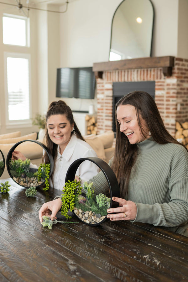 girls making wall terrariums