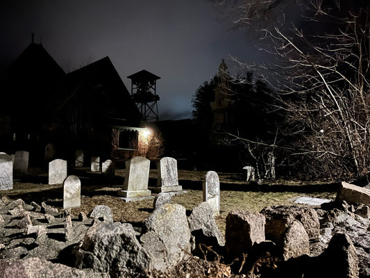 person in front of graveyard