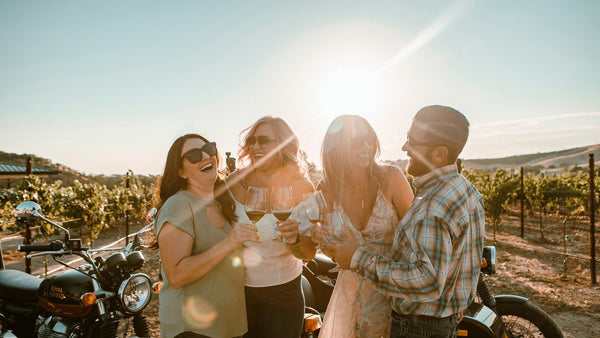 group in vineyard with wine glasses.jpeg