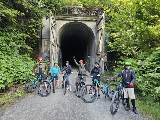 group of bikers in front of tunnel