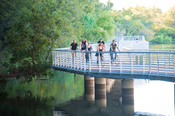 group riding over bridge