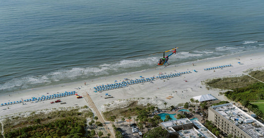 family on beach with helicopter.webp