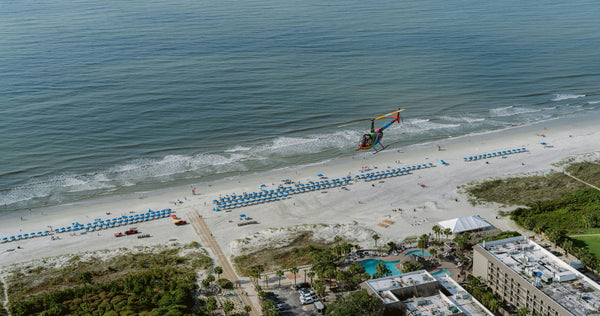 family on beach with helicopter.webp