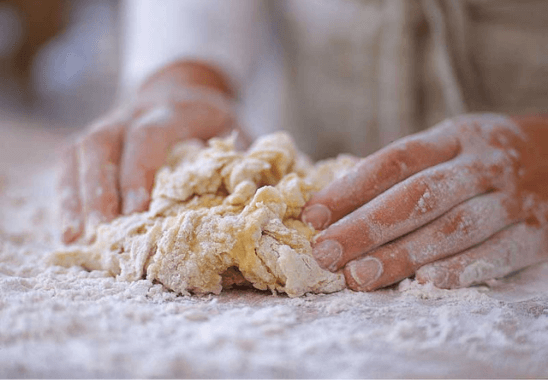 kneading pasta dough for dinner