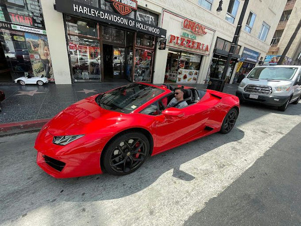 Driving lambo with distance hollywood sign