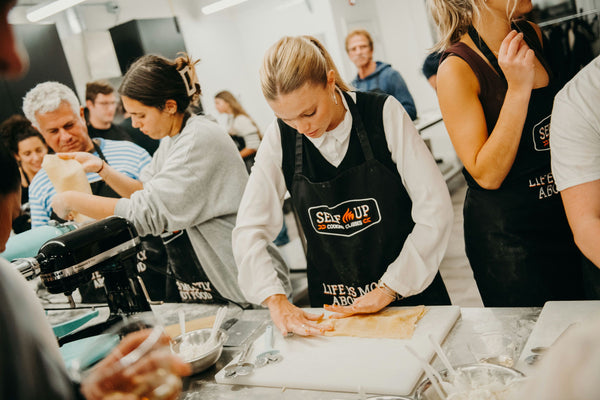 feeding pasta through maker