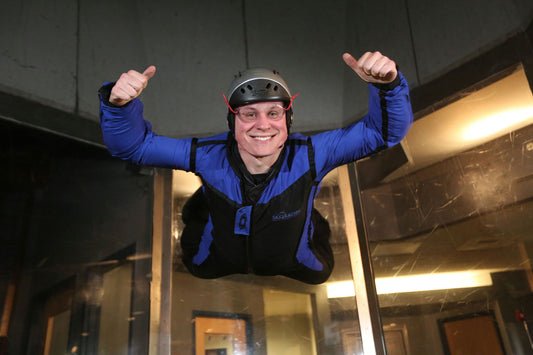 kid with help indoor sky diving