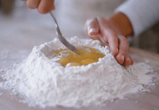 kneading pasta dough for dinner