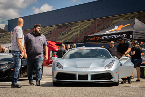 2 men with red ferrari