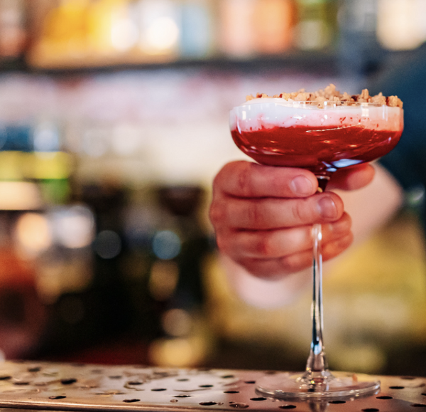 person holding holiday cocktail