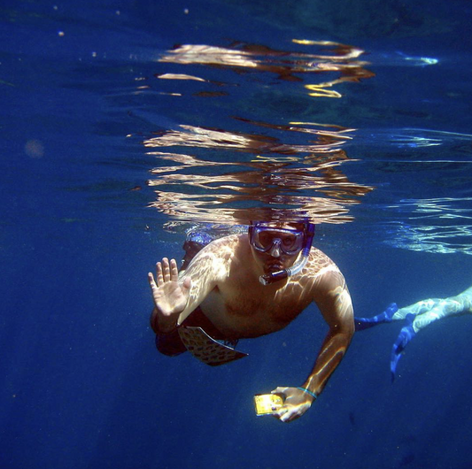 person snorkeling with camera