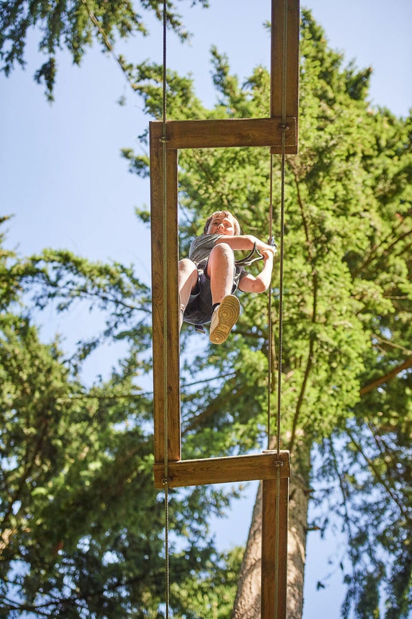 man yelling while zip lining with friends