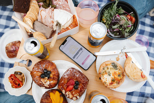 picnic food on blanket with phone