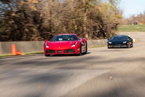 black and red car racing on track