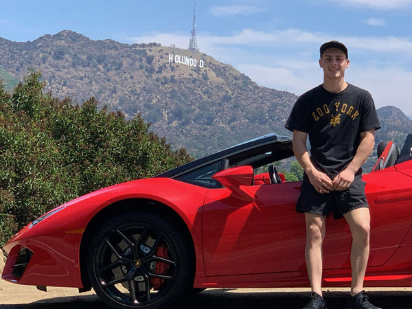 Lambo parked on street with palm trees