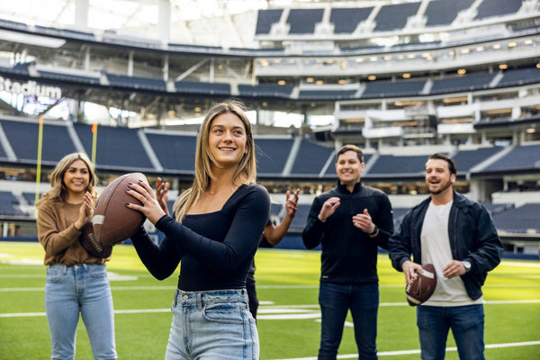 throwing football on field