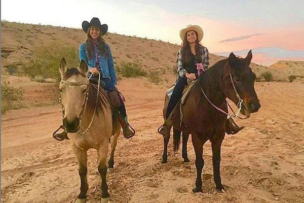 two girls riding horses