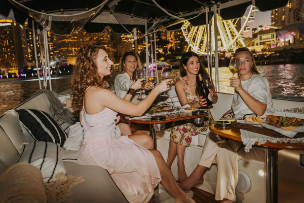 friends on a boat with wine