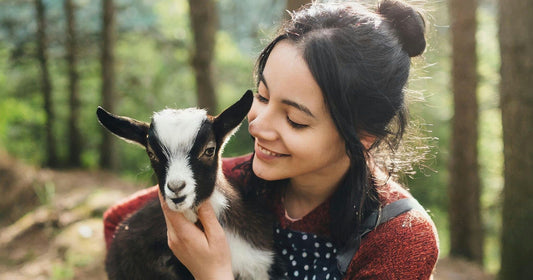 woman cuddling goat.jpeg