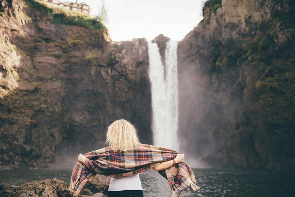 woman in front of waterfall