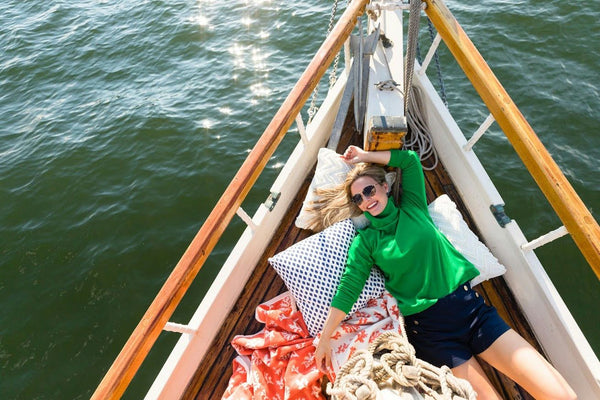 woman laying on sailboat