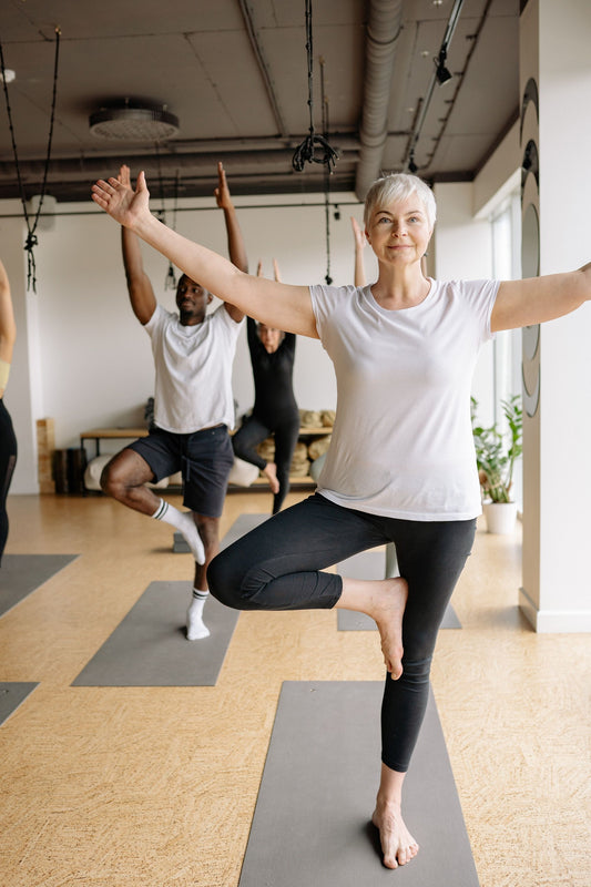 group yoga class on grey mats