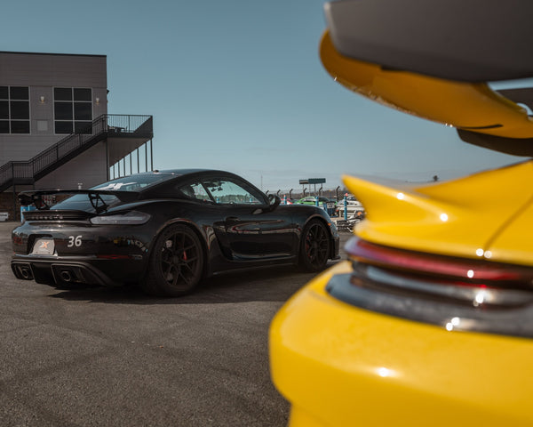 yellow porsche driving fast