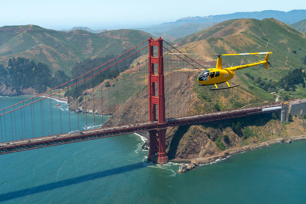 yellow helicopter and golden gate bridge